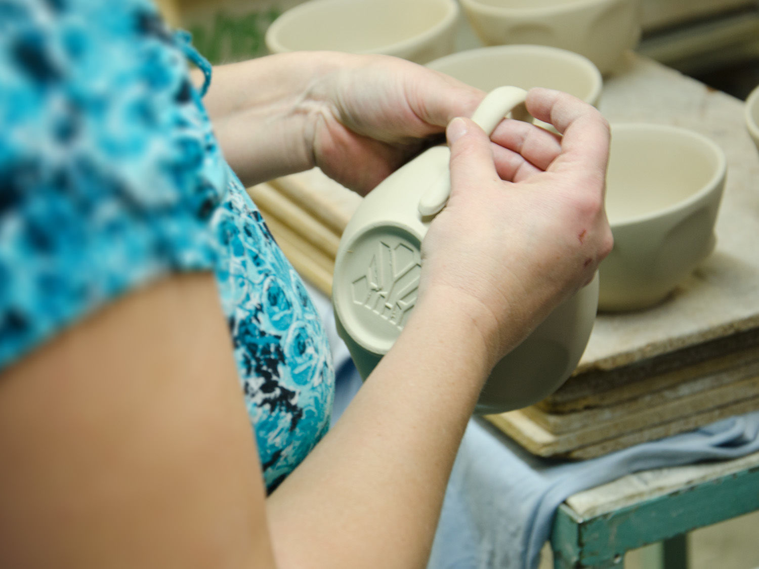 “You’re trying to manufacture what?!” When Ralph Engelmann returns to BHS headquarters with samples of FIFTYEIGHT’s emotional bowls, not everyone shares his enthusiasm. “Our experts in porcelain development simply could not believe it at first, they were completely flabbergasted,” said Engelmann. “This is never going to work”, “We have never done anything like this before” were some of the initial responses. But Engelmann gives his seasoned porcelain technicians a pep talk and encourages them to give the challenging process of bringing TASSEN into serial production a try. On that note, what makes the manufacturing process for grinning faces on TASSEN bowls and cups so demanding? “The TASSEN line of products requires a fundamental paradigm shift in the porcelain manufacturing industry,” said Engelmann. “Initially, the paradigm in the porcelain business revolved around achieving the most consistent thickness of the porcelain, also known as body thickness or shard thickness, throughout a product. Consistent thickness ensures a constant drying of the porcelain after being poured into molds, as well as uniform results after firing the porcelain in the high-temperature oven. All these factors are also fundamental requirements for serial production at high quality levels.” The samples Engelmann obtained from FIFTYEIGHT at the tradeshow completely go against the grain of established rules: “FIFTYEIGHT’s 500ml bowls were really the exact opposite of consistent body thickness,” said Ralph Engelmann, “because even in the most impossible spots such as the back of the character’s head there are indentions. For our internal development team, this presented enormous challenges we needed to overcome.” Drawing on their extensive know-how, the technicians worked on making the impossible possible, and bringing the TASSEN into a serial production run. “Ultimately, we succeeded in producing a prototype that was ready to go into larger manufacturing run. And what’s more, the resulting products not only ended up meeting the high standards defined by FIFTYEIGHT for quality and design of its products. They also met the desired increase in production output, assisted by the flexible logistics services provided by BHS, that FIFTYEIGHT PRODUCTS had defined in its growth strategy,” said Engelmann.